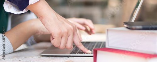 Fotografi Hand of woman college student pressing computer notebook button, concept of back