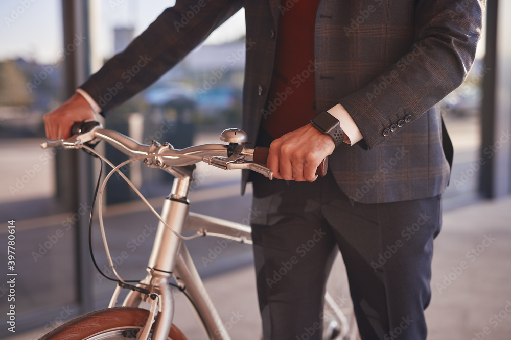 Elegant businessman with bicycle on street Elegant businessman with bicycle on street