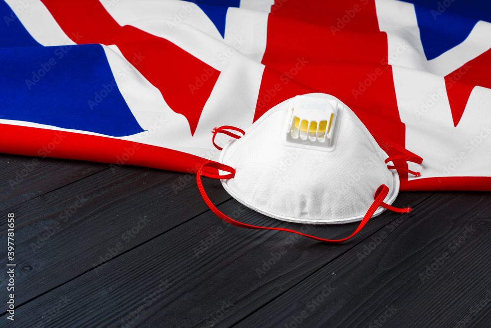Fototapeta premium Medical mask on flag of United Kingdom