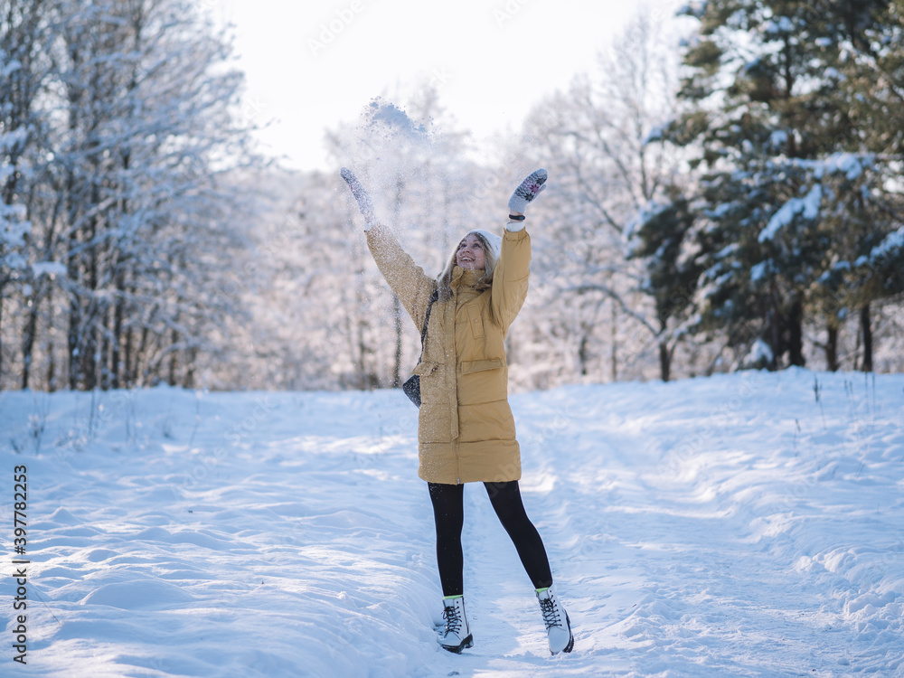 Happy girl always throws snow, winter time, lifestyle and walks in a snow Park or forest. Happy girl always throws snow, winter time, lifestyle and walks in a snow Park or forest.