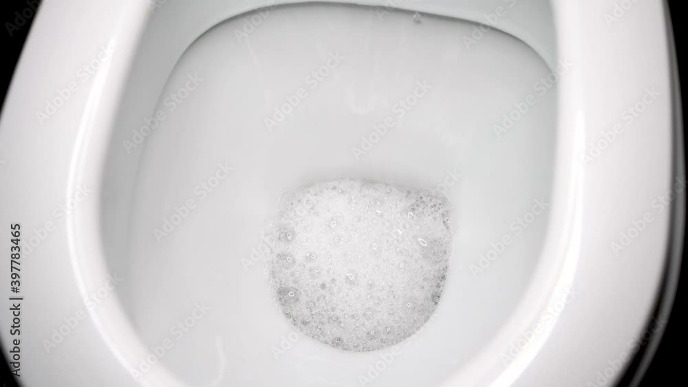Flush the toilet close-up. White clean toilet, flushing water large Flush the toilet close-up. White clean toilet, flushing water large