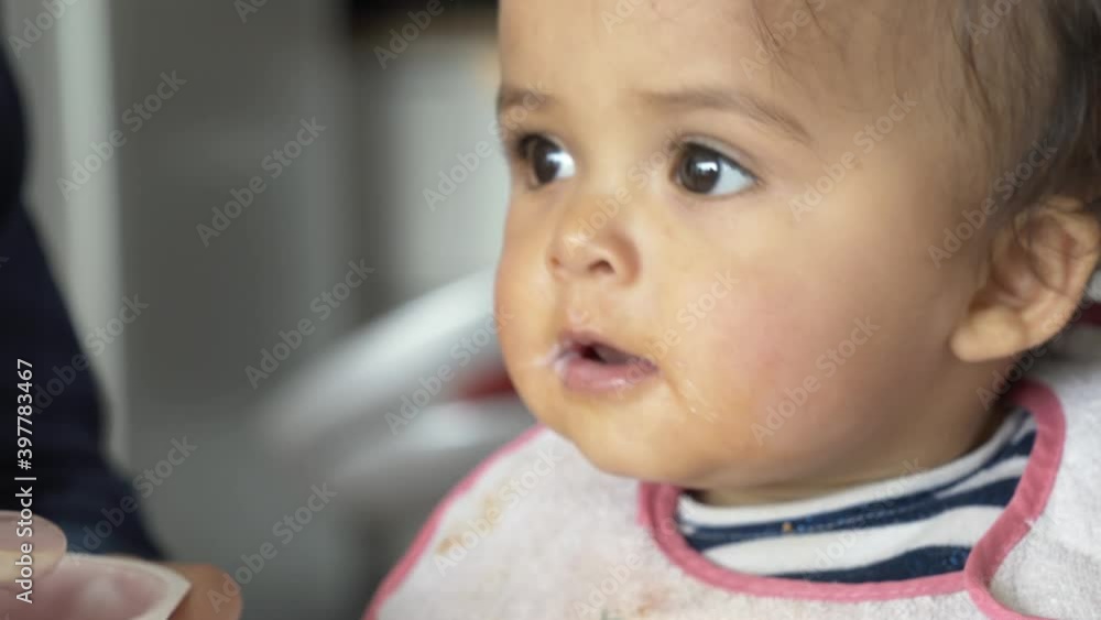 Portrait of 8-month-baby girl eating yoghurt Portrait of 8-month-baby girl eating yoghurt