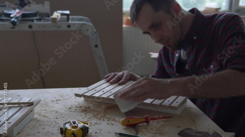 Eco toys and musical instruments made of wood. A master carpenter makes a handmade xylophone for children.