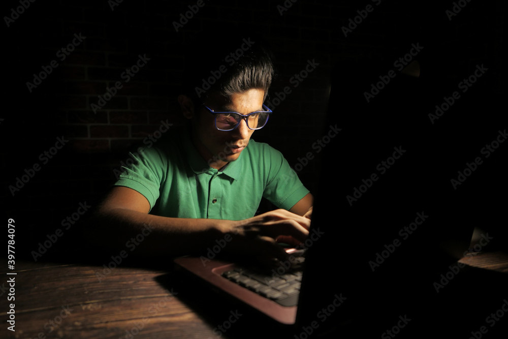 young man working on laptop stealing personal data young man working on laptop stealing personal data