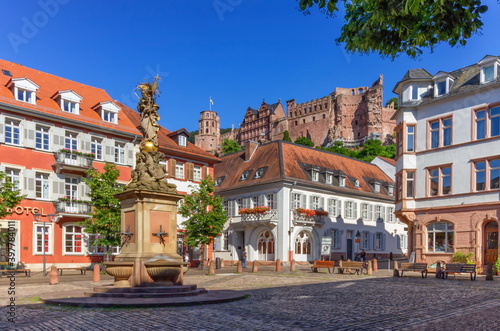 The Madonna statue in Kornmarkt square and castle in Heidelberg by day, Germany