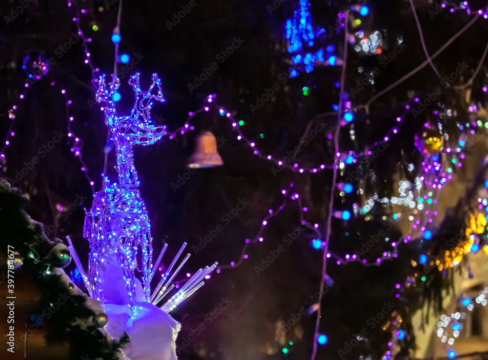 Christmas decoration of the roof of the hut at night.Focus on the figure on the left Christmas decoration of the roof of the hut at night.Focus on the figure on the left