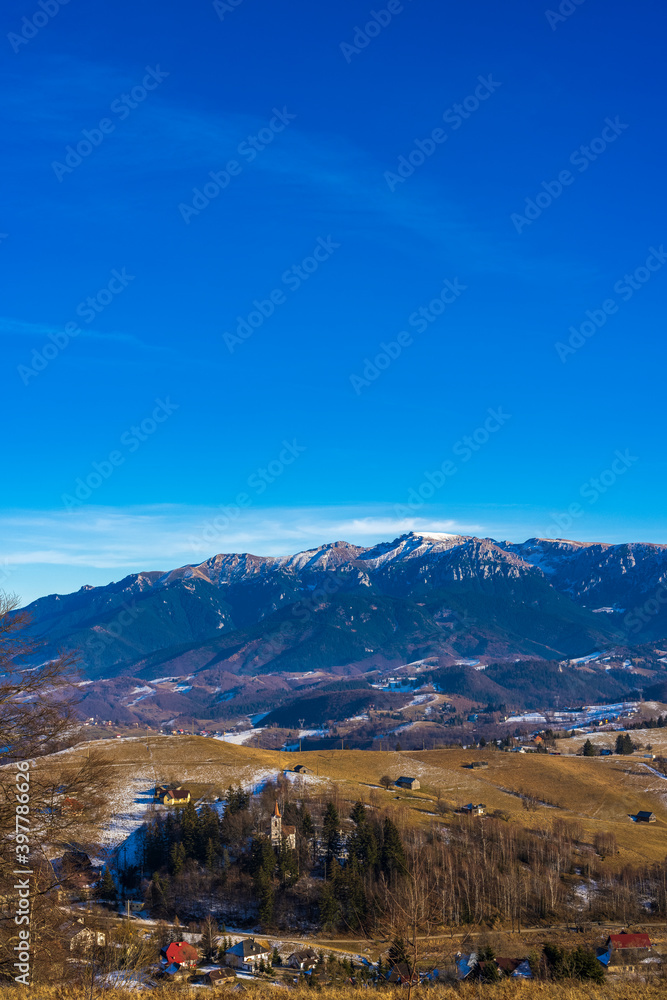 Beautiful mountain landscape in the Carpathian Mountains Romania at the transition from autumn to winter.