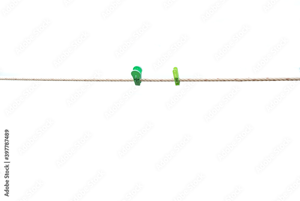 Colorful wooden clothespin hanging on rope. isolated on the white background. Colorful wooden clothespin hanging on rope. isolated on the white background.