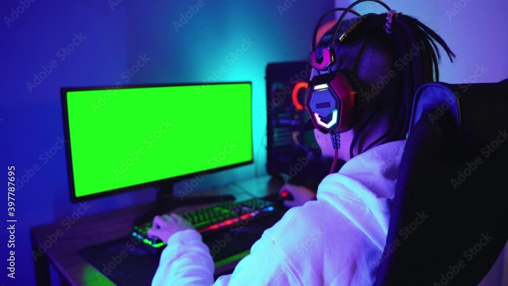 Young man intensely plays a computer game, chroma key on the screen Young man intensely plays a computer game, chroma key on the screen