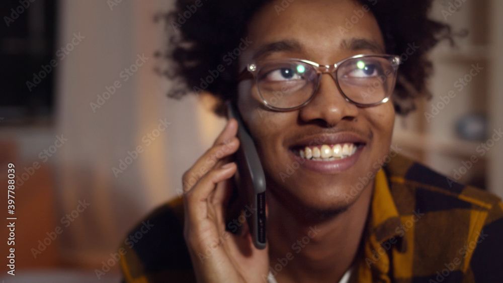 Close up of cheerful african man having phone home at home Close up of cheerful african man having phone home at home