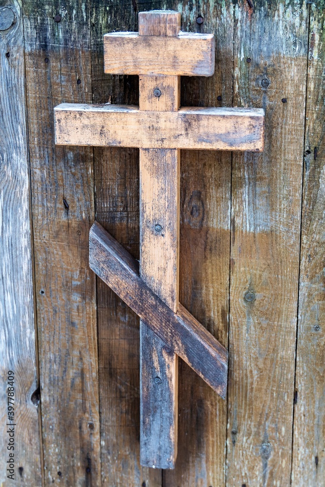 Wooden Orthodox cross on the door of the church.