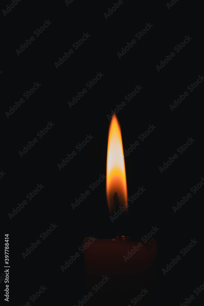 The flame on the candle black background. The flame on the candle black background.