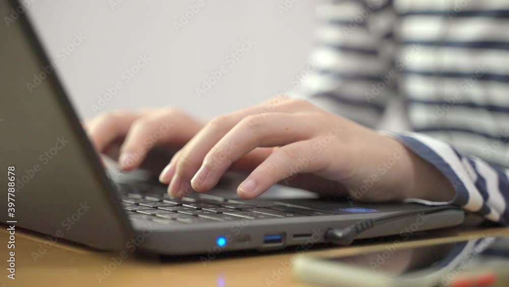 Young woman’s hands typing on her laptop computer’s keyboard in slow motion - working from home concept Young woman’s hands typing on her laptop computer’s keyboard in slow motion - working from home concept