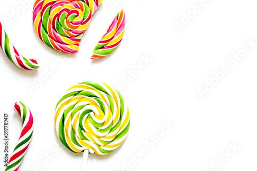 Delicious sugar lollipops on white background top view space for text
