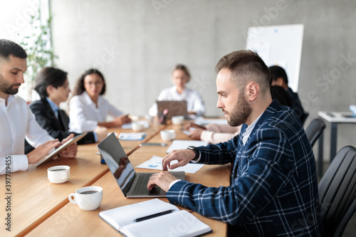 Businessman Using Laptop Working During Corporate Meeting In Modern Office