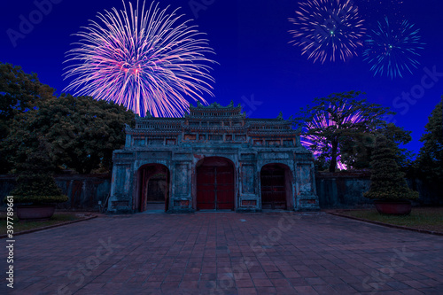 Celebratory fireworks for new year over Gate of the Forbidden imperial City at Hue, Vietnam during last night of year. Christmas atmosphere. 