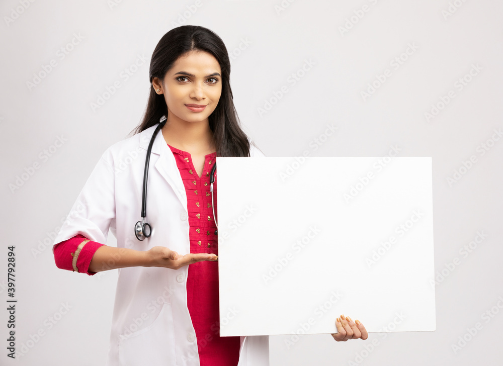 Female doctor holding a sign board on white Female doctor holding a sign board on white