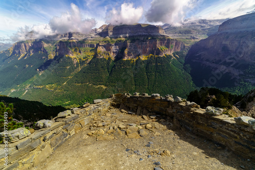 Green landscape in the Pyrenees of the Ordesa and Monte Perdido valley with mountains, rocks, forests and sky with clouds. Top aerial view.
 photo