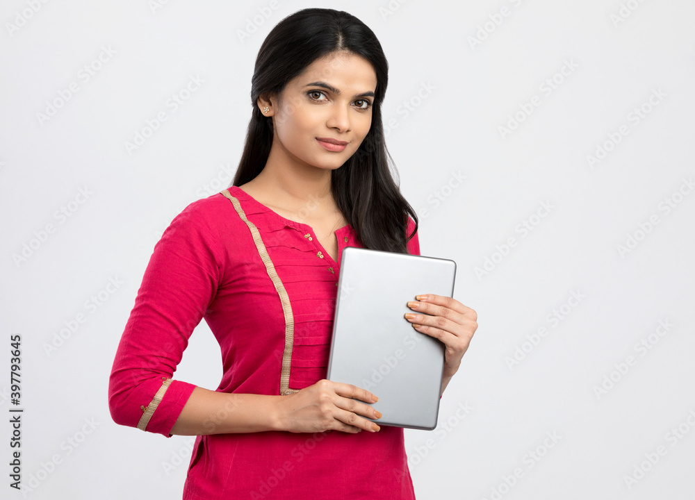 Happy Indian young woman with digital tablet on white. Happy Indian young woman with digital tablet on white.