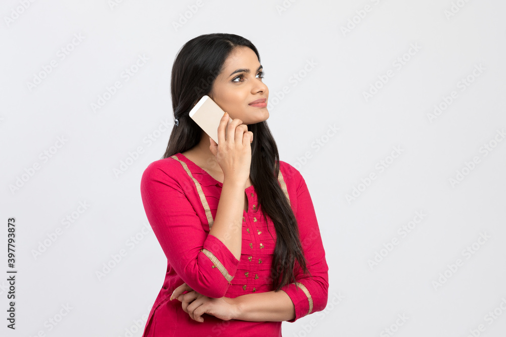 Pretty young woman talking in smart phone on white. Pretty young woman talking in smart phone on white.