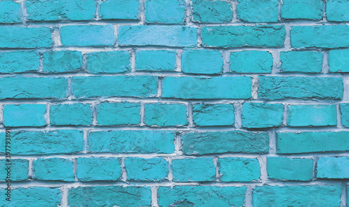 The wall of the building is made of old blue bricks and white cement. Background.