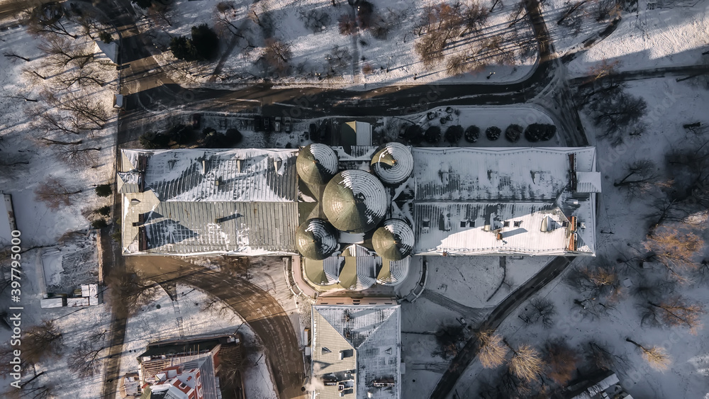 Top view of the ancient temple with domes. Historic building in the park. Snowy and beautiful winter.