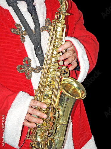 SaxophoneSanta Claus in a red fur coat  playing the saxophone