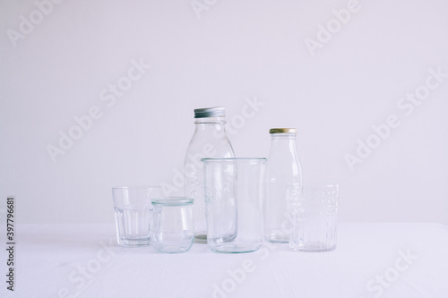 Set of empty bottles and jars on the top of a table with white background