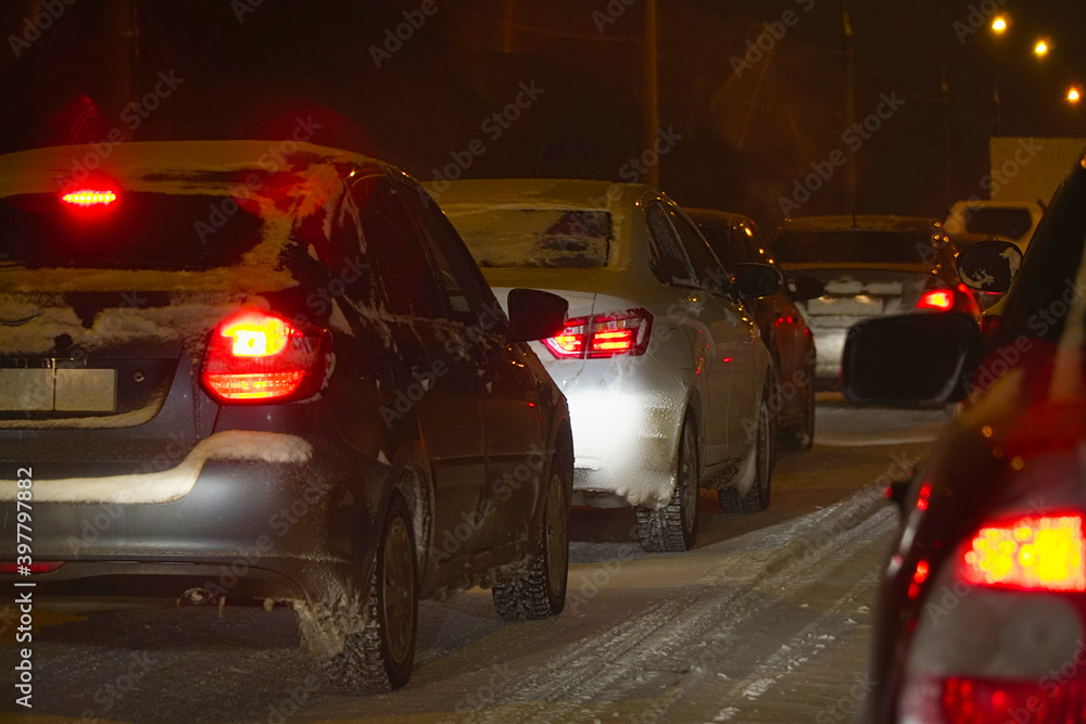 Cars in traffic in winter in the evening dark or at night Cars in traffic in winter in the evening dark or at night