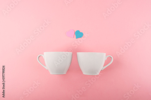 Two cups of coffee on a pink background. Valentine's day concept.