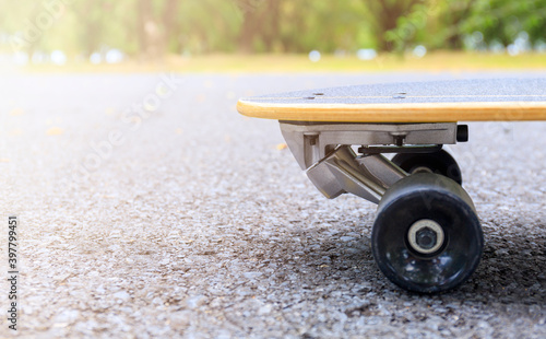 Close up skateboard on morning at park. Head of skateboard and wheel on road at public park. Sport concept.