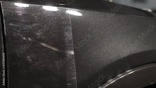 Manual car wash. A man washes his sedan from a special hose. Manual portable car wash. Detailed and gentle car care
