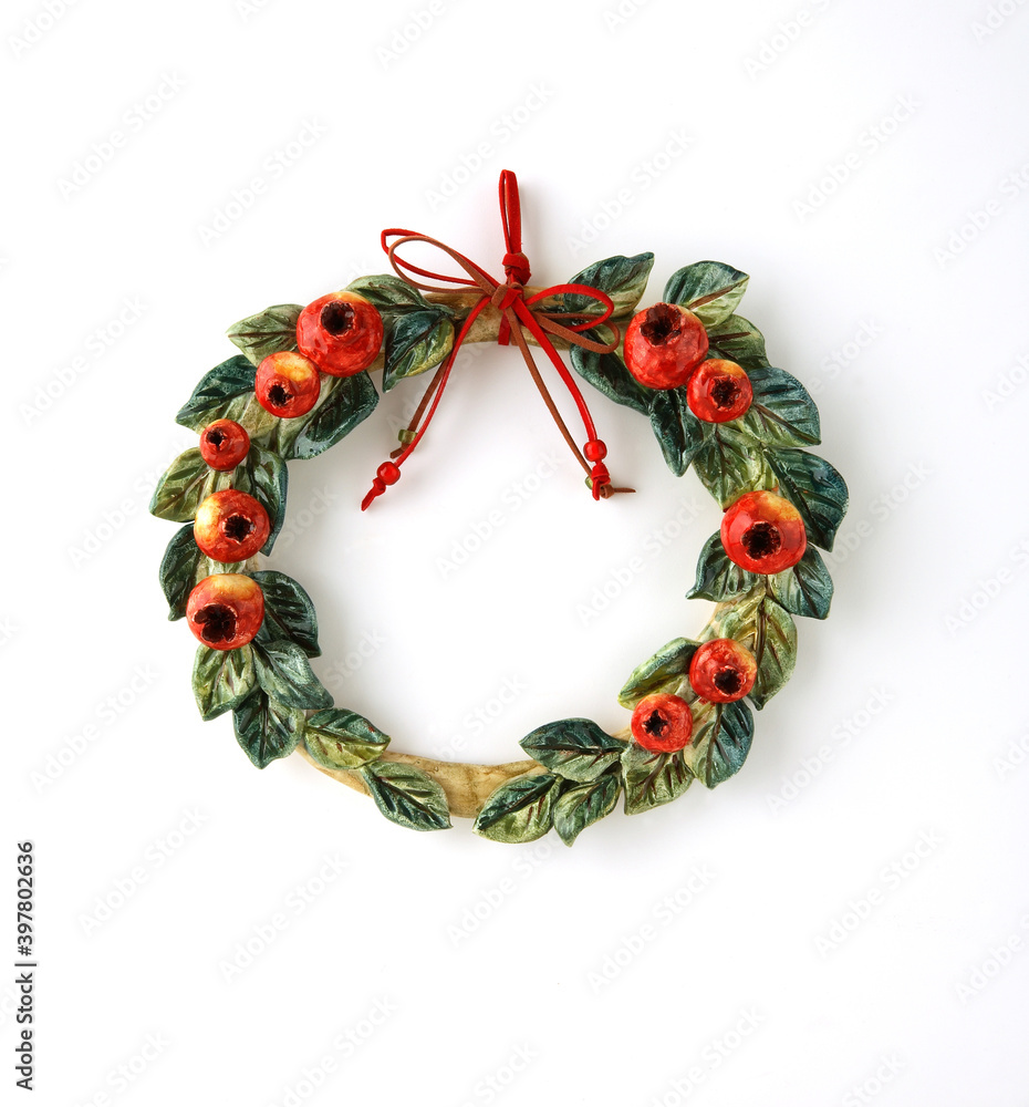 Christmas wreath with pomegranates on white background