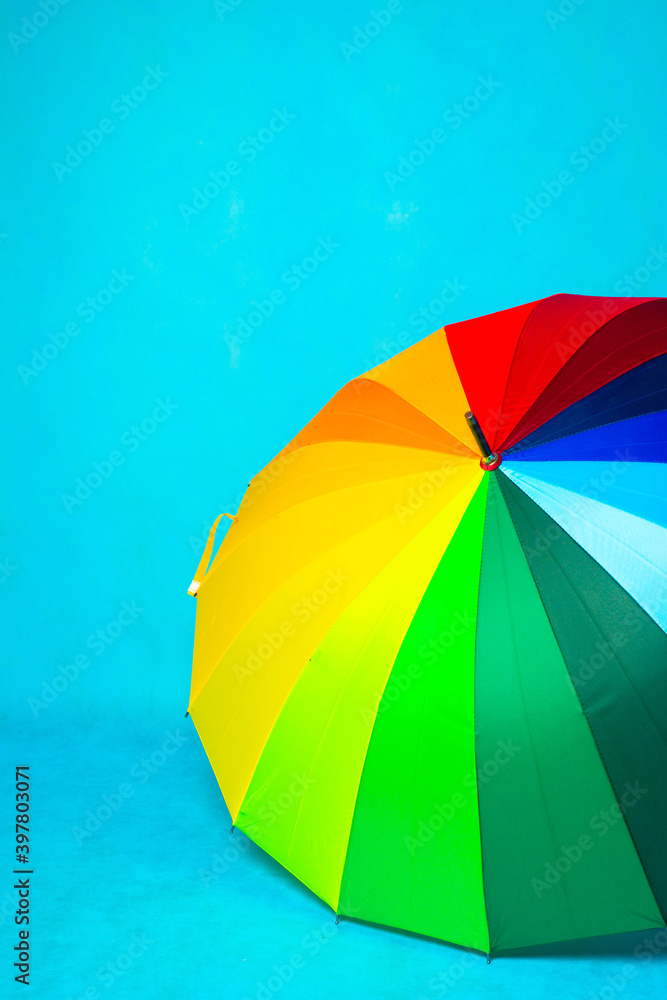 Colored umbrella on a blue background . Bright umbrella. Copy space. Colored umbrella on a blue background . Bright umbrella. Copy space.