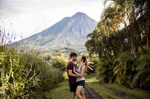 Photography couple hiking in costa rica around volcano