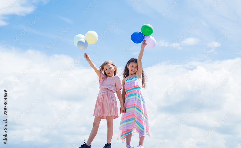 two sisters hold party balloon. happy childhood. summer vacation. small girls embrace. love and support. concept of sisterhood and friendship. family bonding time. best friends with balloon two sisters hold party balloon. happy childhood. summer vacation. small girls embrace. love and support. concept of sisterhood and friendship. family bonding time. best friends with balloon
