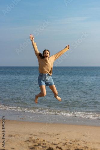 picture of pretty girl on the beach  portrayed playing with the waves of the sea