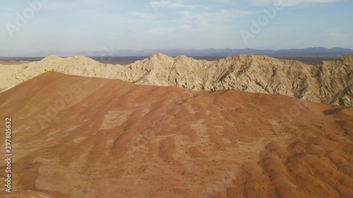 Aerial view of UAE's Al Faya mountain range landscape, Sharjah's Kalba mountains in the background, Al Faya desert, United Arab Emirates. 4k winter drone footage photo