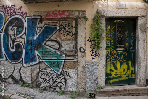 Graffiti-covered house in street of Lisbon, Portugal
