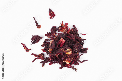 Hibiscus tea dried flowers heap on white background. Vitamin, recipe, beverage concept. Top view, flat lay, copy space