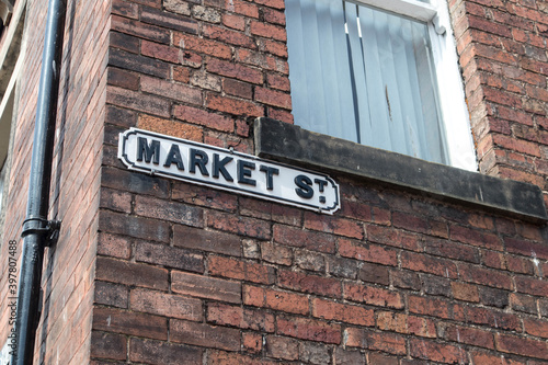 Market Street road sign on an old brick wall of a house.