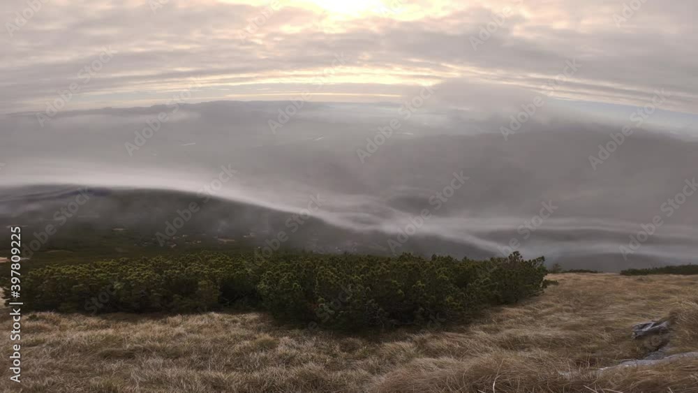 Mystic clouds flows over mountains in sunny autumn nature Mystic clouds flows over mountains in sunny autumn nature