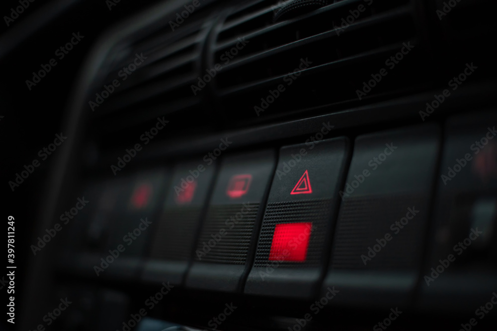 Emergency button highlighted in red on the instrument panel close up Emergency button highlighted in red on the instrument panel close up