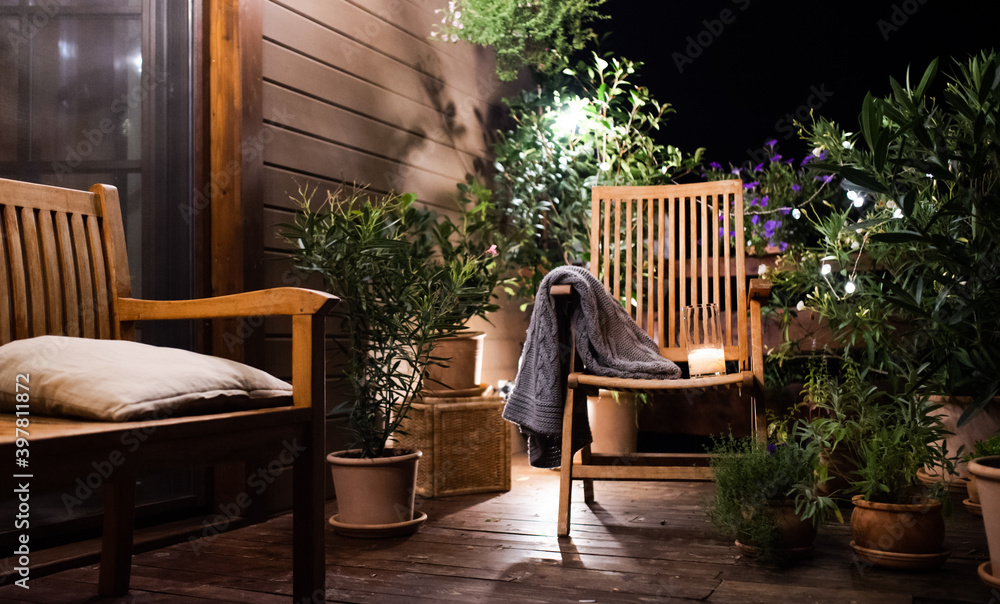 Obraz premium Candle on chair in the evening on terrace in summer.