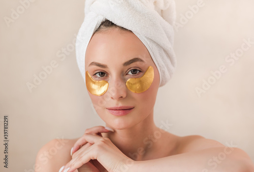 Beauty face woman natural healthy cosmetic skin pure suresh beautiful female happy smile portrait manicure hand. Beauty portrait of an attractive girl with a gold patch under the eyes.