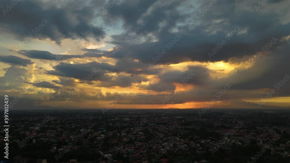 Aerial Drone shot of Sunset with beautiful cloud formation over urban city, tracking , orbiting Aerial Drone shot of Sunset with beautiful cloud formation over urban city, tracking , orbiting