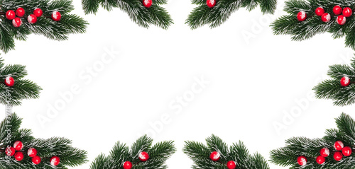 Decorative Christmas snowy frosty fir twigs with red berries encircling copy space in the middle. Banner size. Isolated on white background. Christmas card and winter holidays decoration concept