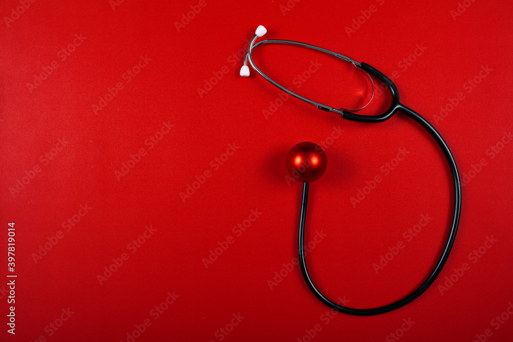 Medical stethoscope with christmas ornament over red background. copy space, medicine greeting card.
Medical stethoscope with christmas ornament over red background. copy space, medicine greeting card.