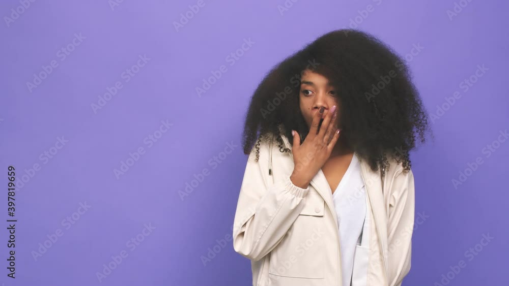 Young african american curly woman touching back of head, thinking and making a choice Young african american curly woman touching back of head, thinking and making a choice