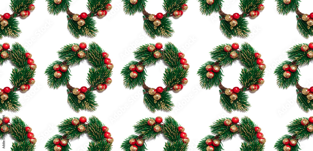 Decorative Christmas wreath woven of spruce branches with red and golden berries. Seamless pattern. Isolated on white background. Top view. Winter holiday decoration concept Decorative Christmas wreath woven of spruce branches with red and golden berries. Seamless pattern. Isolated on white background. Top view. Winter holiday decoration concept